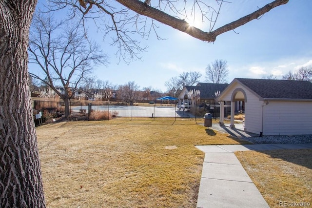 view of yard featuring a water view and fence