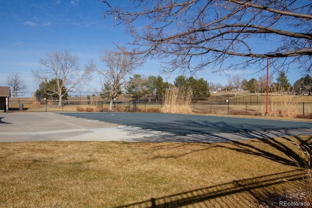 view of pool with a lawn and fence