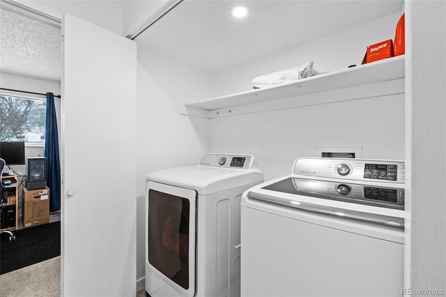 laundry area featuring a textured ceiling, laundry area, and washer and dryer