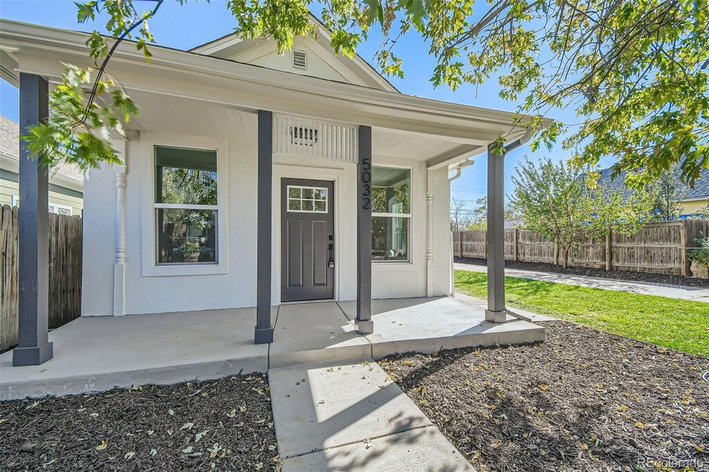 view of exterior entry with a porch