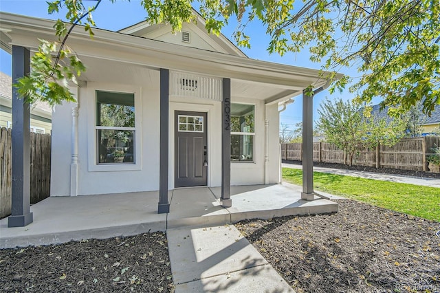 view of exterior entry with a porch