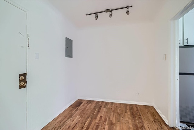 85 N Grant St Unit 22, Denver, CO 80203 - washroom with wood finished floors, baseboards, rail lighting, and electric panel