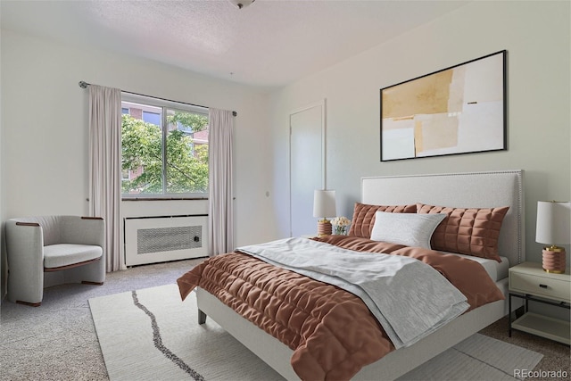 carpeted bedroom featuring a textured ceiling