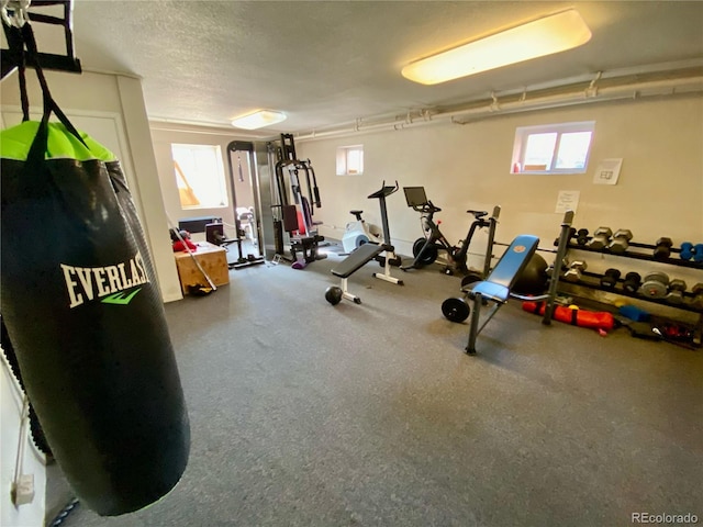 workout room featuring a textured ceiling