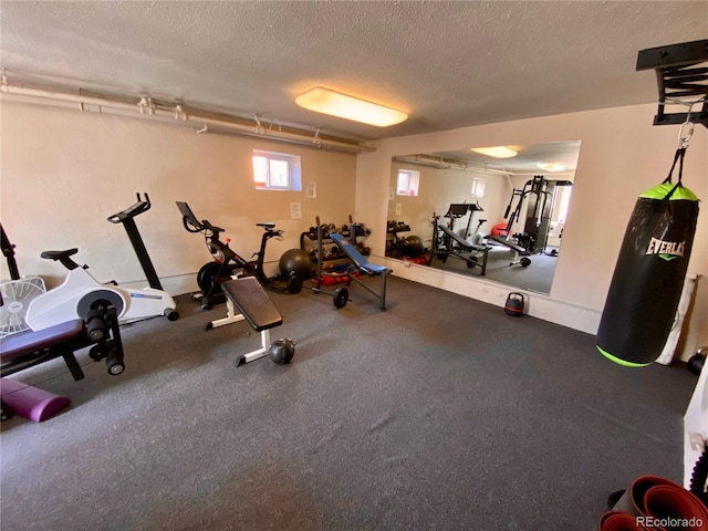 workout area featuring a textured ceiling