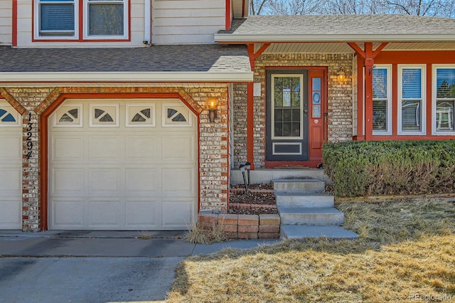 doorway to property featuring stone siding, an attached garage, concrete driveway, and roof with shingles