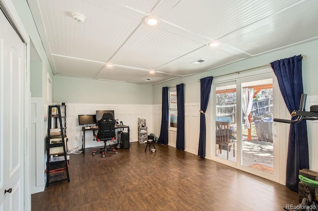 home office featuring wood finished floors and a wainscoted wall