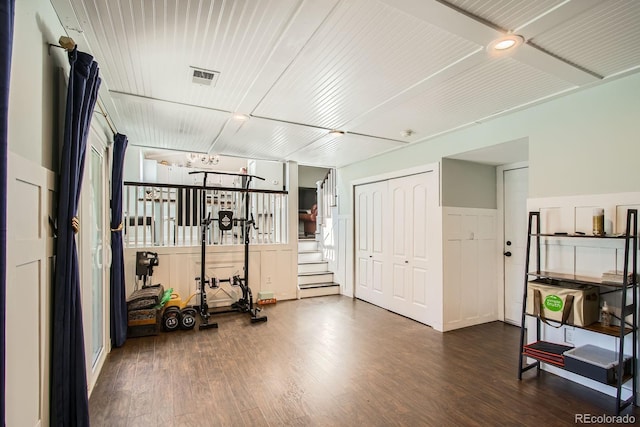 exercise area with wood finished floors and visible vents