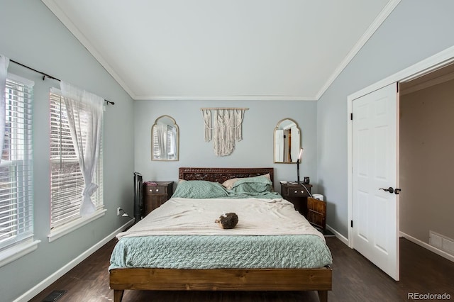 bedroom with visible vents, ornamental molding, dark wood-style floors, baseboards, and vaulted ceiling