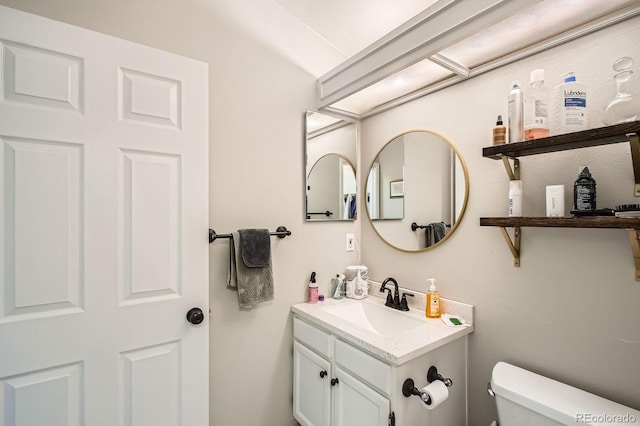 half bath with vanity and toilet