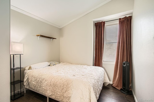 bedroom with baseboards, dark wood-type flooring, lofted ceiling, and crown molding