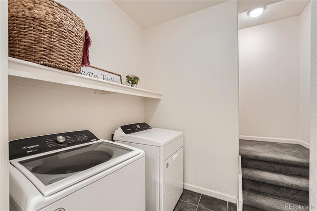 803 E 98th Ave Unit 105, Thornton, CO 80229 - washroom with washing machine and clothes dryer, dark tile patterned flooring, and baseboards