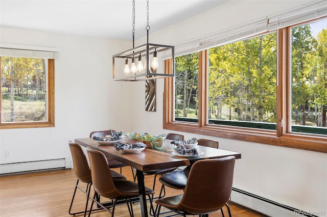 dining area with plenty of natural light and a baseboard radiator