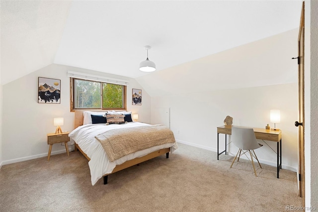 carpeted bedroom featuring vaulted ceiling and baseboards