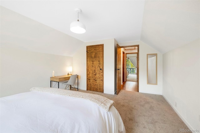 bedroom featuring baseboards, vaulted ceiling, and carpet flooring