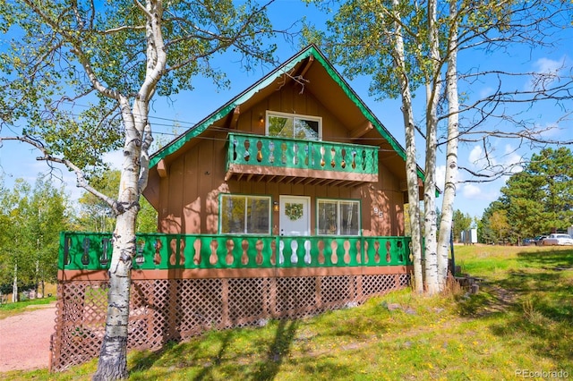 view of side of home featuring a balcony