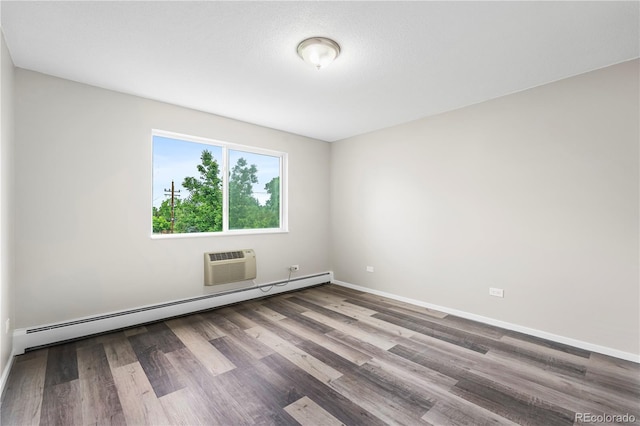 795 S Alton Way Unit 11C, Denver, CO 80247 - unfurnished room featuring baseboard heating, wood finished floors, a wall mounted AC, and baseboards