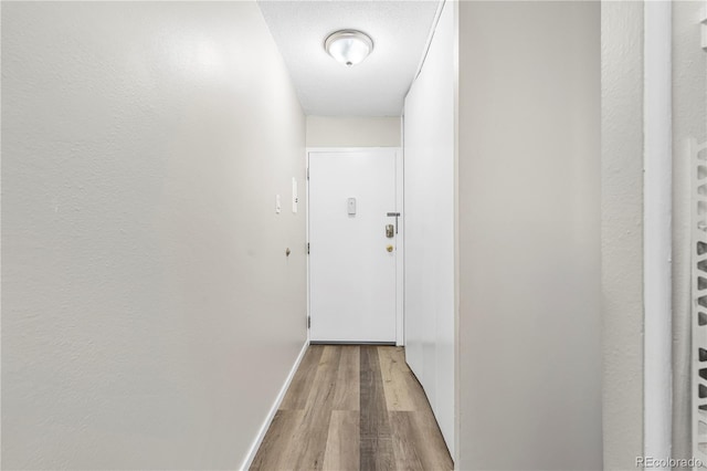 795 S Alton Way Unit 11C, Denver, CO 80247 - corridor with light wood-type flooring and baseboards