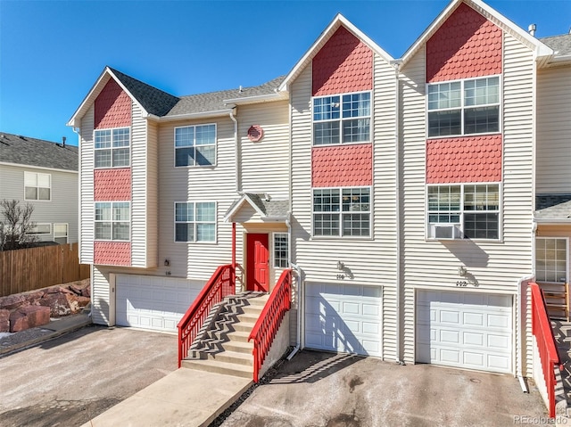 view of property with an attached garage and driveway