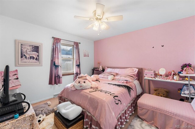 carpeted bedroom featuring baseboards and ceiling fan