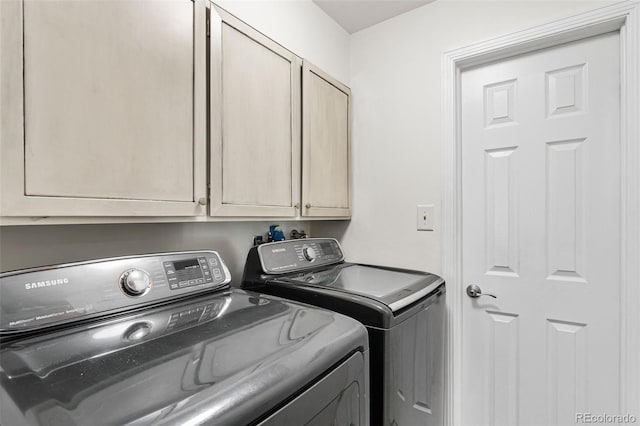 laundry area featuring washer and dryer and cabinet space