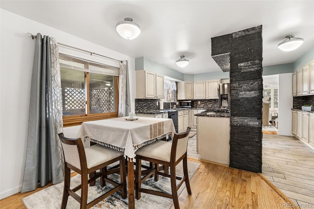 3191 S Holly Pl, Denver, CO 80222 - dining space featuring light wood-style floors and ornate columns