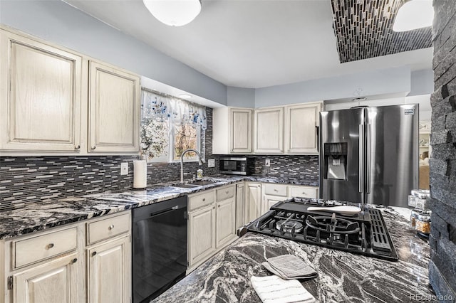 3191 S Holly Pl, Denver, CO 80222 - kitchen with appliances with stainless steel finishes, a sink, backsplash, dark stone counters, and cream cabinets
