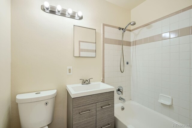 full bath featuring vanity, toilet, and shower / washtub combination