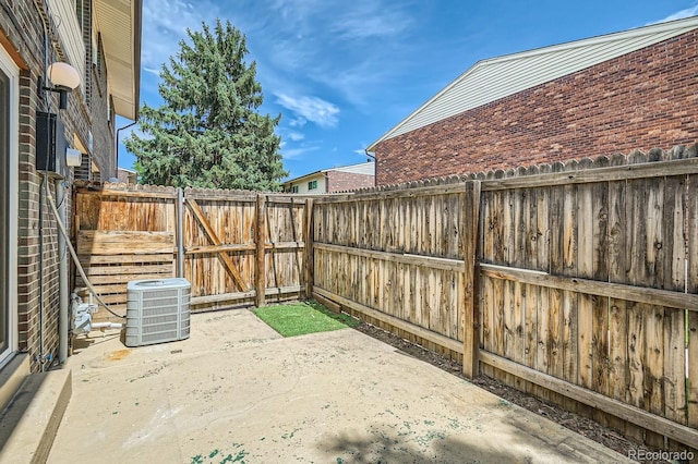 8039 Wolff St Unit E, Westminster, CO 80031 - fenced backyard with central air condition unit, a patio area, and a gate