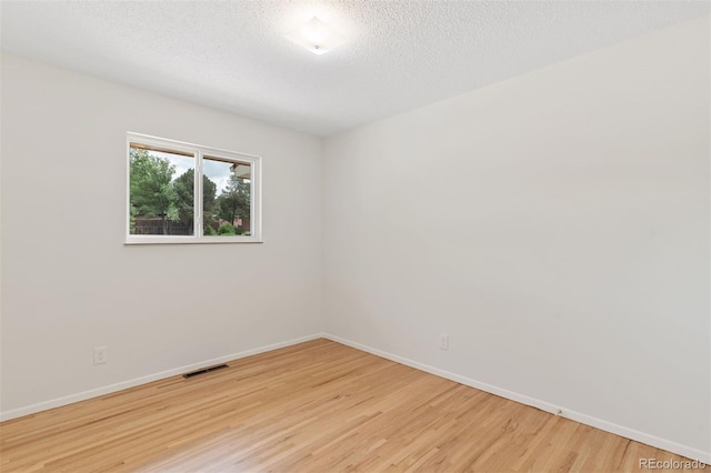 1411 Acacia Dr, Colorado Springs, CO 80907 - empty room featuring light wood finished floors and a textured ceiling