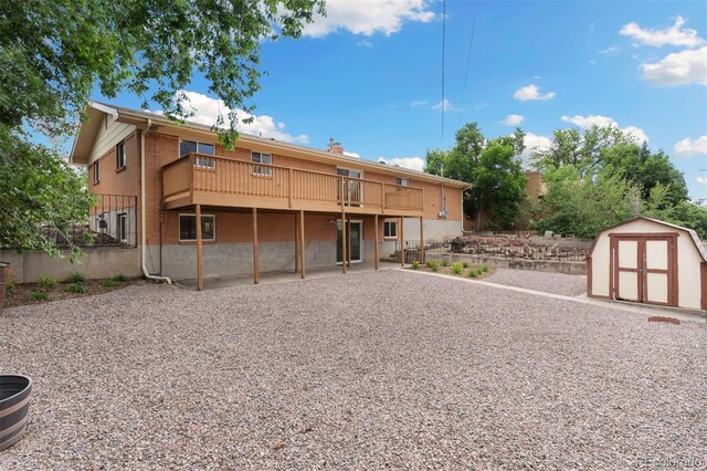 1411 Acacia Dr, Colorado Springs, CO 80907 - back of property featuring a storage shed, a deck, and a patio