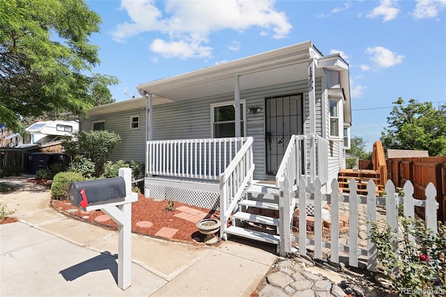 1455 W Alaska Pl, Denver, CO 80223 - manufactured / mobile home with a porch