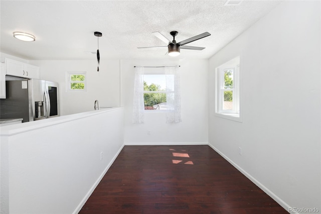 1455 W Alaska Pl, Denver, CO 80223 - unfurnished room with dark wood finished floors, ceiling fan, and a textured ceiling