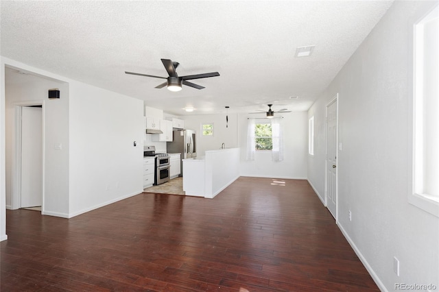 1455 W Alaska Pl, Denver, CO 80223 - unfurnished living room featuring a ceiling fan, dark wood-style floors, and a textured ceiling