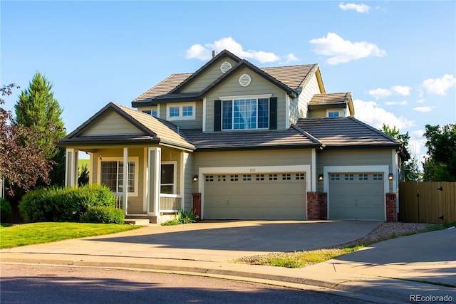 3232 Cimarron Pl, Superior, CO 80027 - view of front of home featuring driveway, brick siding, a tile roof, and a garage