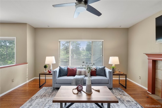 3232 Cimarron Pl, Superior, CO 80027 - living area with a ceiling fan, wood finished floors, and a tiled fireplace