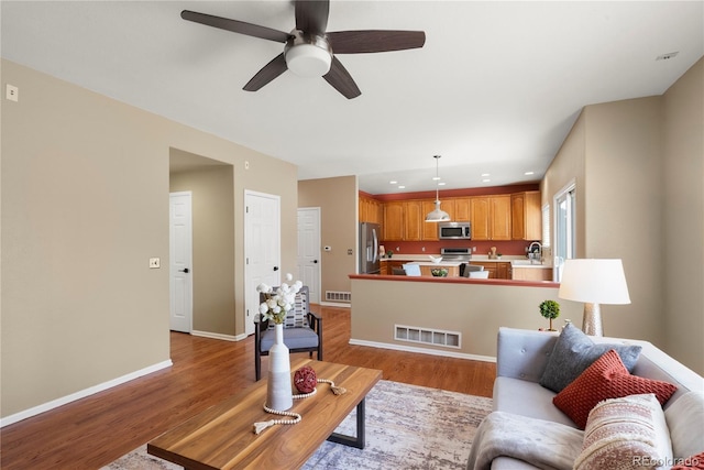 3232 Cimarron Pl, Superior, CO 80027 - living area with light wood finished floors, ceiling fan, and recessed lighting