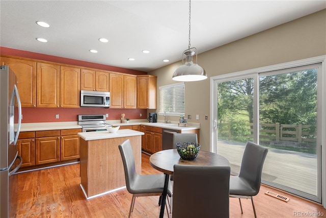 3232 Cimarron Pl, Superior, CO 80027 - kitchen with appliances with stainless steel finishes, recessed lighting, light countertops, a center island, and light wood-style floors
