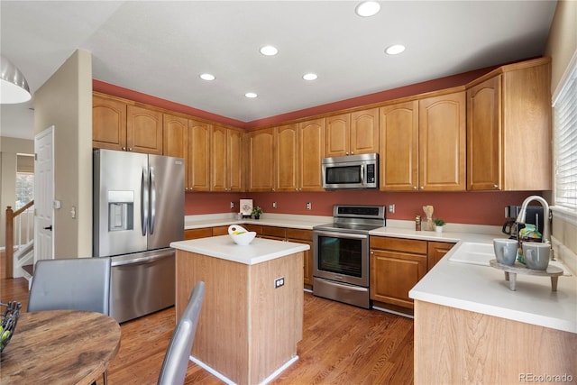 3232 Cimarron Pl, Superior, CO 80027 - kitchen featuring appliances with stainless steel finishes, recessed lighting, a center island, light countertops, and light wood-style floors