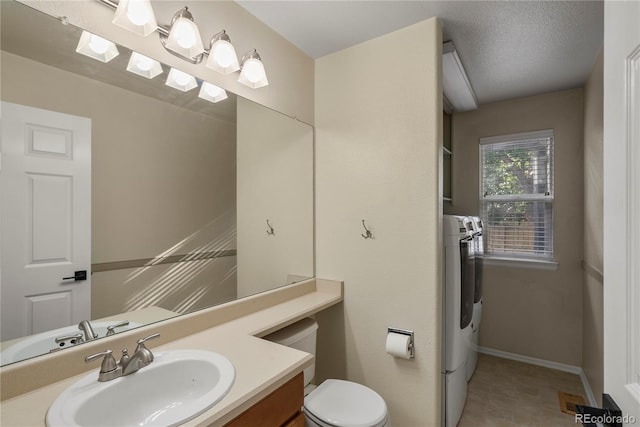 3232 Cimarron Pl, Superior, CO 80027 - bathroom with vanity, washer and clothes dryer, and tile patterned flooring