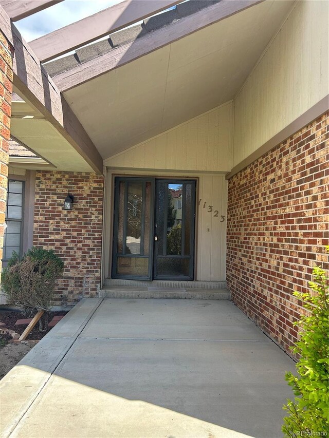 11323 E Cimmarron Dr, Englewood, CO 80111 - doorway to property featuring brick siding