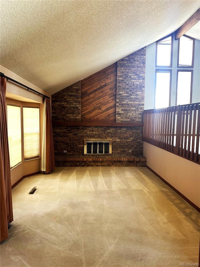11323 E Cimmarron Dr, Englewood, CO 80111 - carpeted empty room featuring a brick fireplace, a textured ceiling, vaulted ceiling, and baseboards