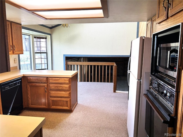11323 E Cimmarron Dr, Englewood, CO 80111 - kitchen with brown cabinets, light colored carpet, light countertops, a peninsula, and black appliances
