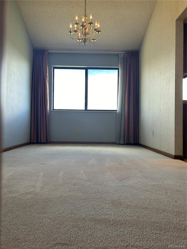 11323 E Cimmarron Dr, Englewood, CO 80111 - spare room with carpet floors, a textured ceiling, and a notable chandelier
