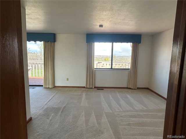 11323 E Cimmarron Dr, Englewood, CO 80111 - empty room with baseboards, visible vents, a textured ceiling, and light colored carpet