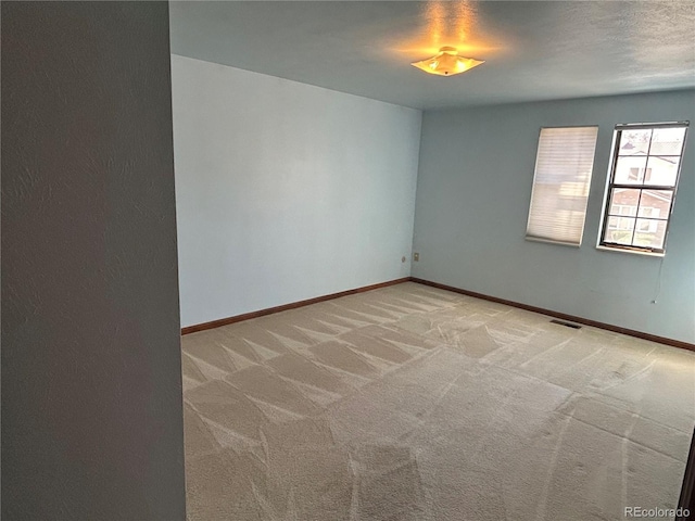 11323 E Cimmarron Dr, Englewood, CO 80111 - empty room featuring baseboards, light carpet, and visible vents