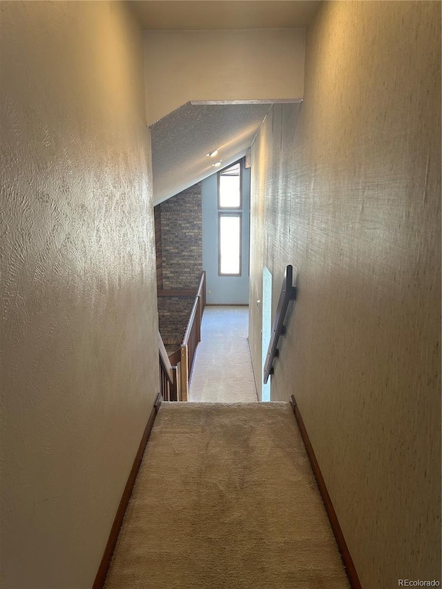 11323 E Cimmarron Dr, Englewood, CO 80111 - hallway with carpet floors, baseboards, vaulted ceiling, and an upstairs landing