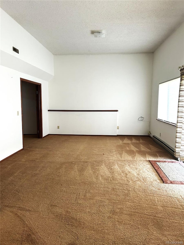 11323 E Cimmarron Dr, Englewood, CO 80111 - carpeted empty room with baseboard heating and a textured ceiling