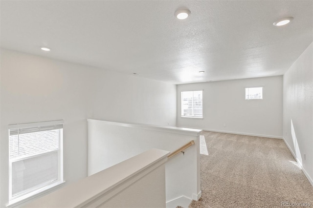18162 Coppermallow Trl, Parker, CO 80134 - hall with an upstairs landing, light colored carpet, recessed lighting, and a textured ceiling