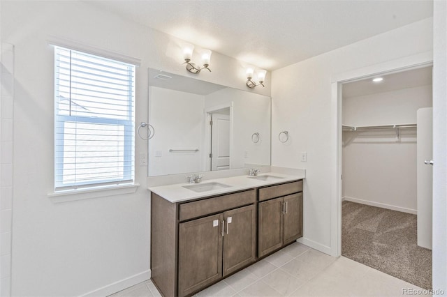 18162 Coppermallow Trl, Parker, CO 80134 - full bathroom featuring double vanity, a spacious closet, and tile patterned flooring